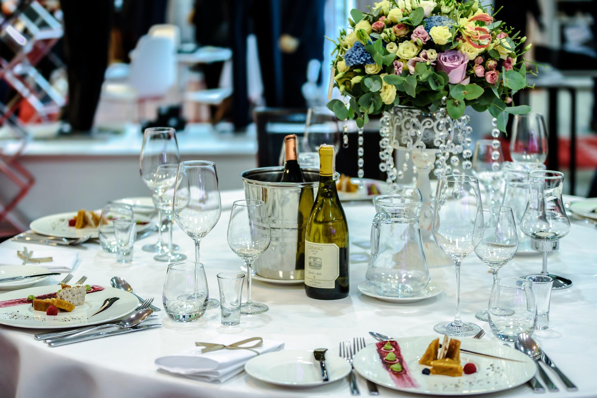 Banquet table setting with flowers and wine