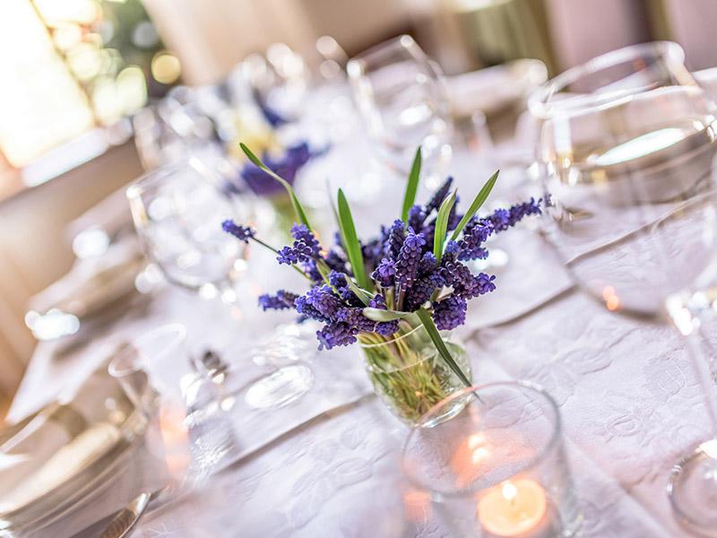 Glasses and a small lavender posy on a laid table