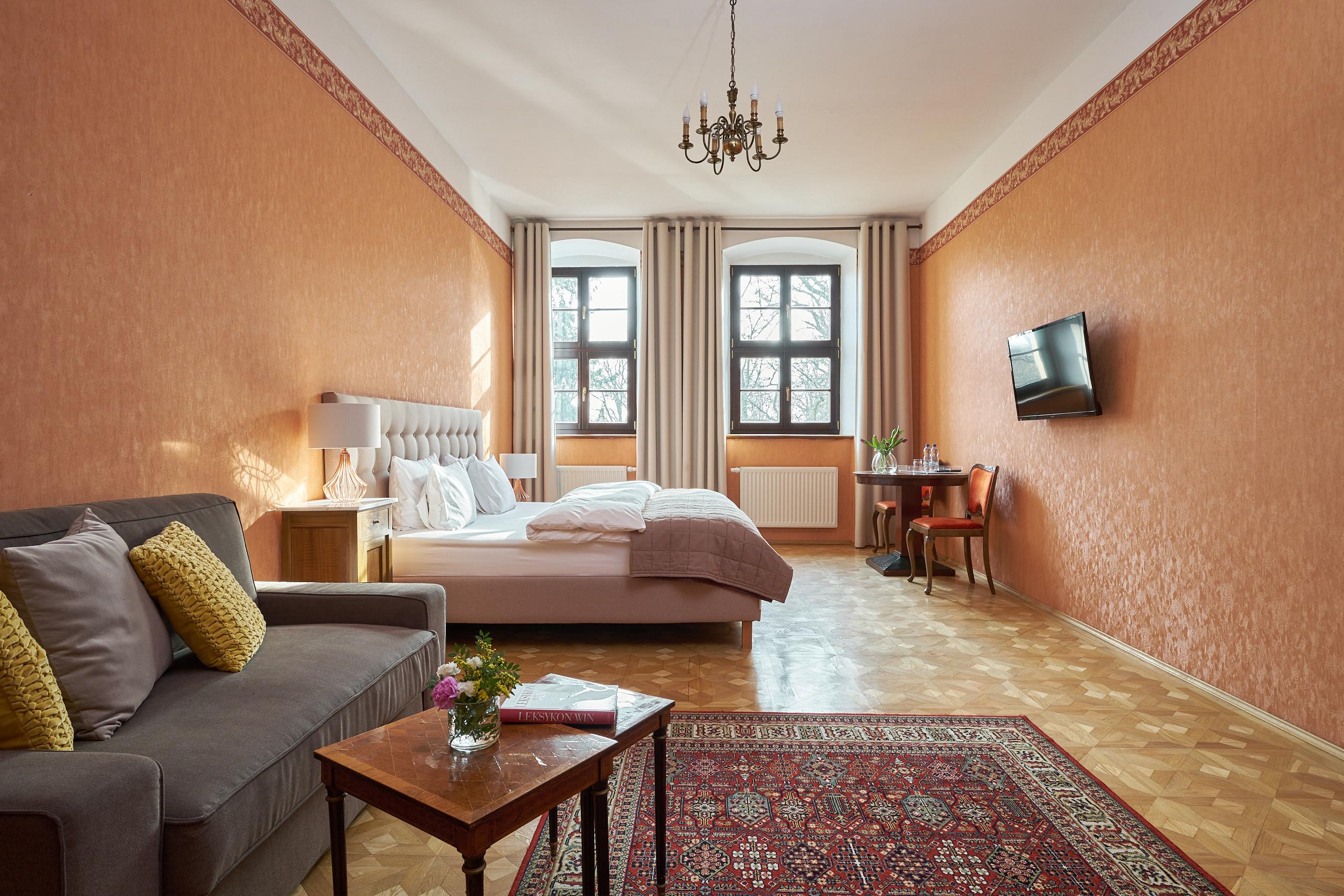 Apartment (orangefarbenes Zimmer): geräumig mit Sofa, Tisch und Teppich