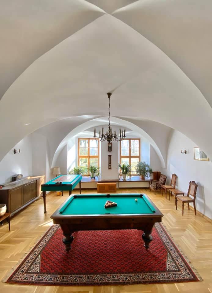 Vaulted room with a billiard table