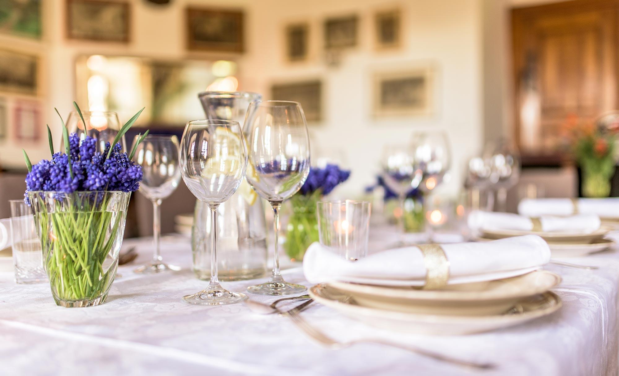 Laid table with hyacinths and glasses in the palace salon