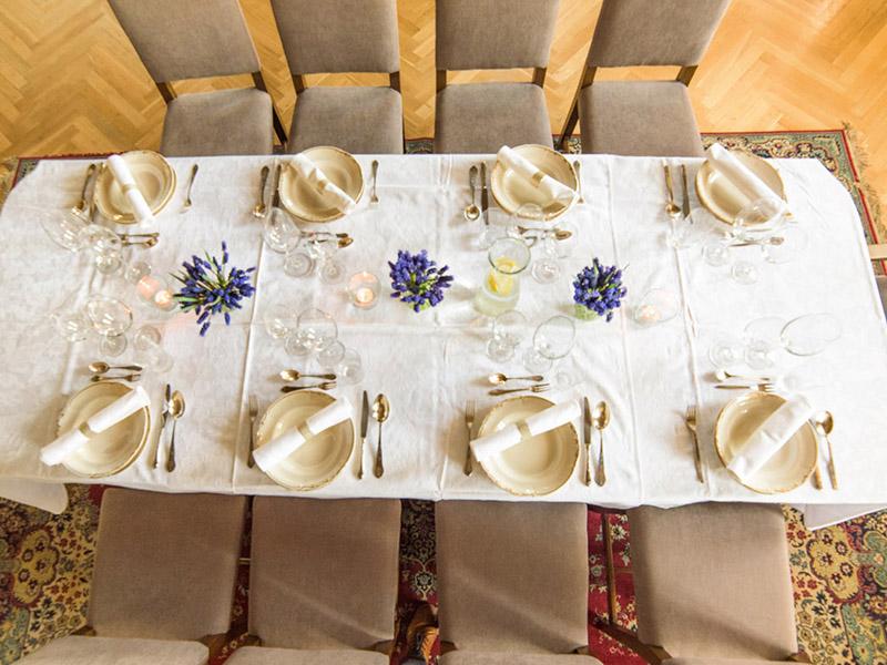 Table laid with white linen and lavender, seen from above
