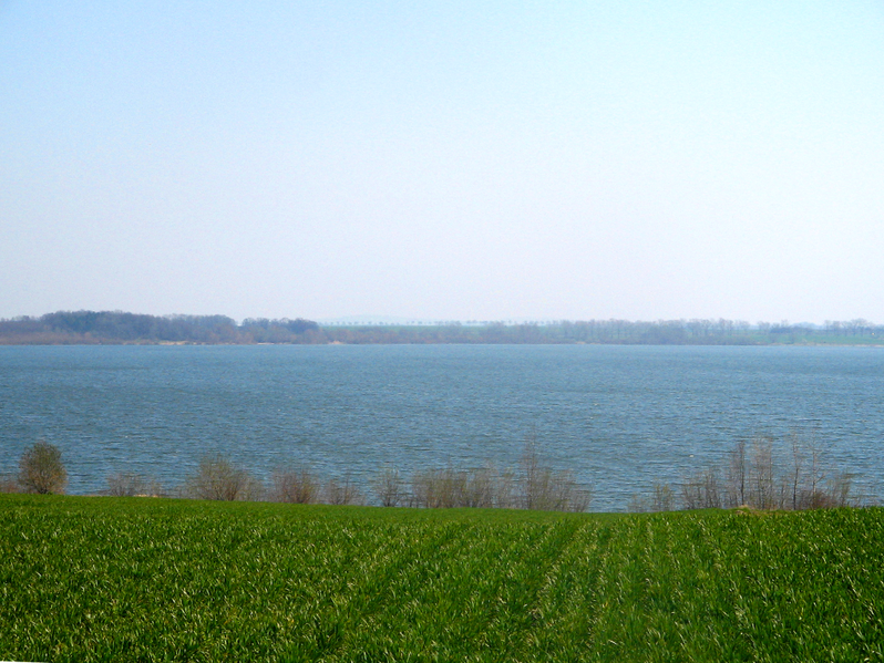Słup Reservoir — a wide expanse of water among fields